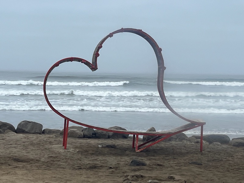 Heart sculpture on a misty beach