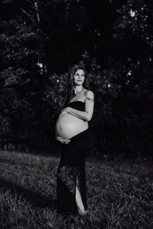 Black and white maternity portrait at golden hour